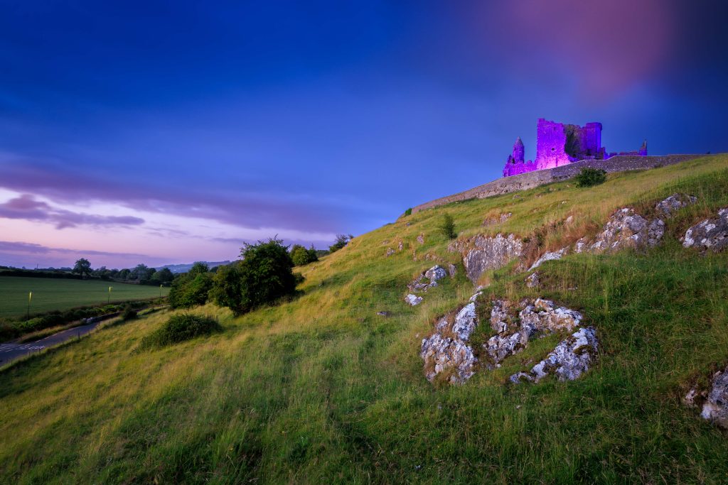 Rock of Cashel lit up in purple